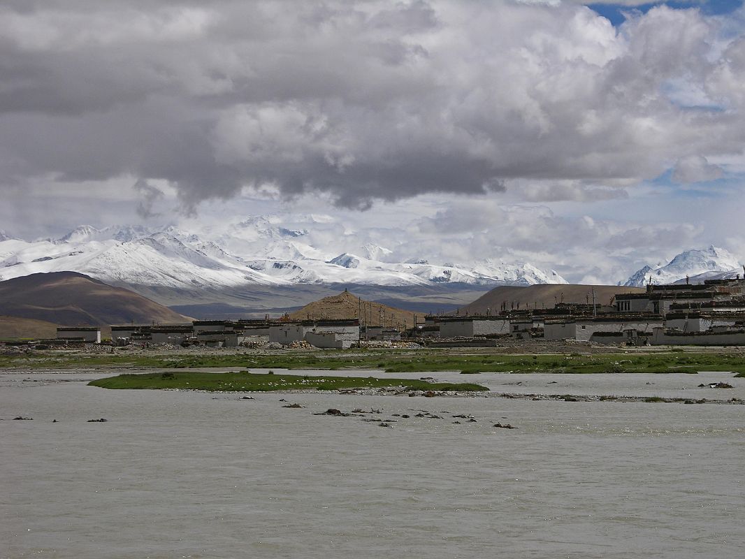 17 Cho Oyu With Monsoon Flooded Tingri Plain And Tingri Village In 2005 To the south of Tingri beyond the monsoon flooding is Cho Oyo (8201m). To Cho Oyu�s right is the Nangpa La pass (5800m) and then Jobo Rabzang. The Nangpa La pass leads from Tibet to the Solo Khumbu region of Nepal by way of Thame and Namche Bazaar. The pass is normally open only from May to August. Jobo Rabzang (6666m) has impressive rock and ice towers just northwest of Nangpa La near the border of Nepal and Tibet.